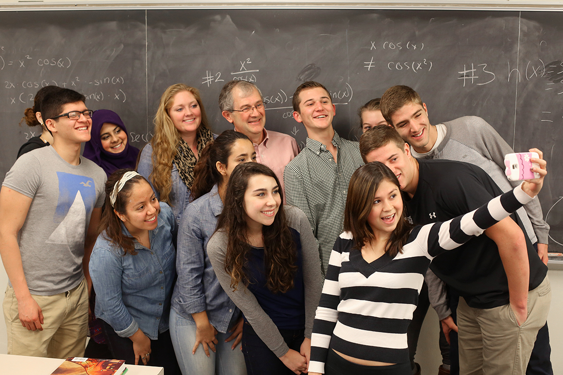 Students taking selfies in a class