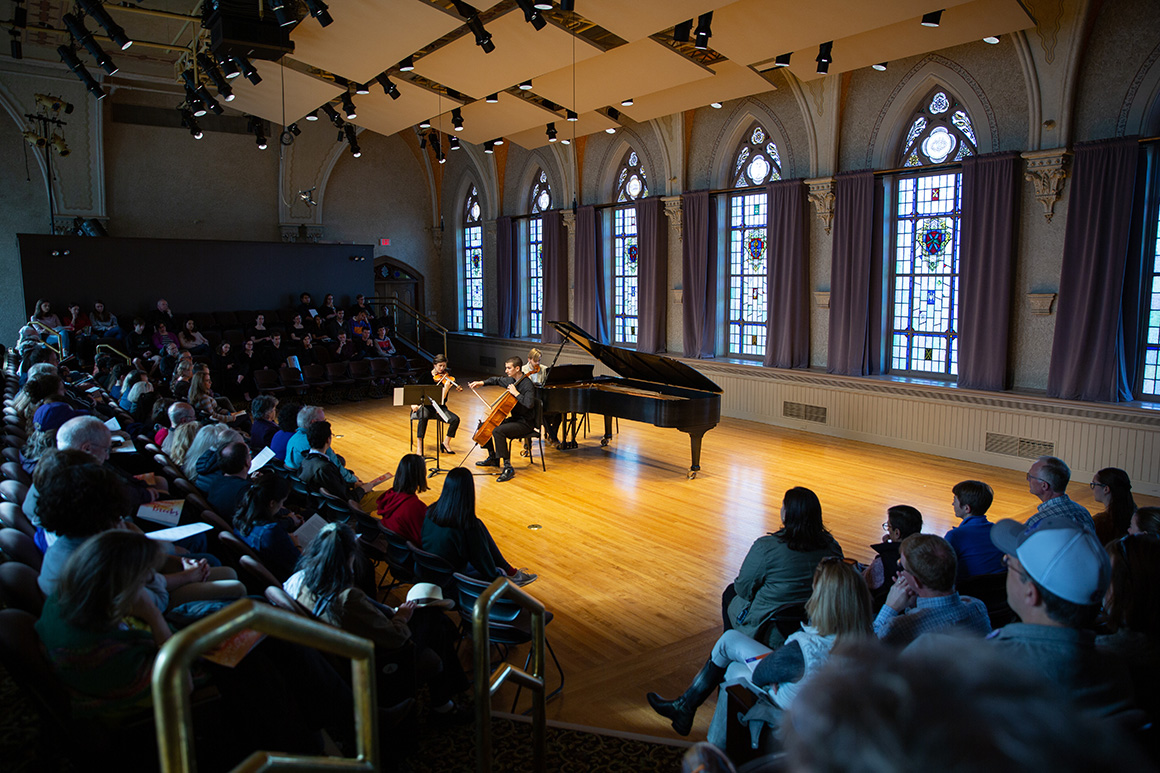 Student a piano in a concert hall