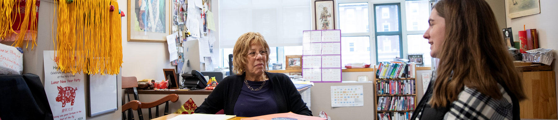 chinese professor claudia ross meeting with a student in her office