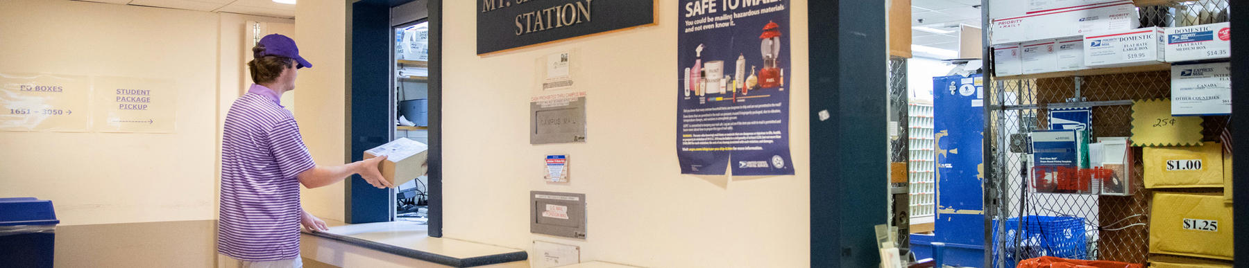 student at a post office window