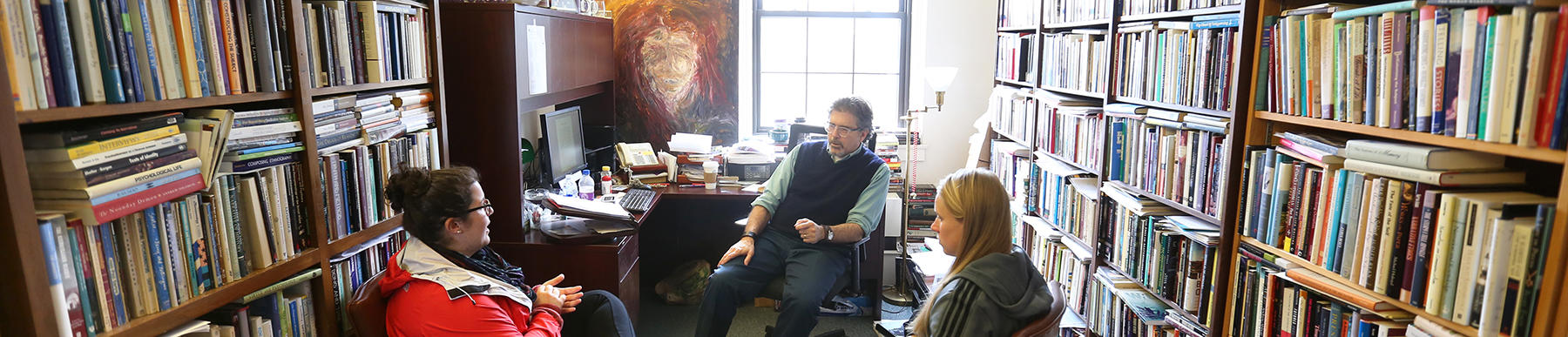 Students in an office with faculty