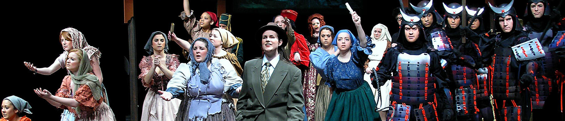 photo of students acting in a theatre production wearing costumes