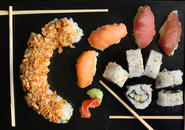 variety of sushi framed by chopsticks