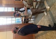 Congressman Jim McGovern, left, stands speaking to a student, right, both wearing face masks, after the event in Rehm Library.