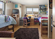 Student sitting at her desk in a Figge Hall room