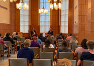 Congressman Jim McGovern (right) and Professor Thomas Ward are seated at the front of the room to address students questions in Rehm Library.