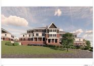 A rendering of what the townhouses will look like. They are modern looking: with a mixture of brick, shake and plank siding. Each townhouse house a pitched roof focal point that is painted a dark color. The second floor is a warm gray and the lower floor is brick with a lot of porch space. The windows are black and the trim around all windows and the home are white. There is a good sized yard with beautiful landscaping.