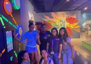 Six students gathered before an art exhibit at an orientation event