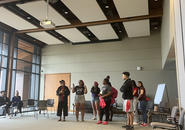 A group of students giving a presentation at an orientation event