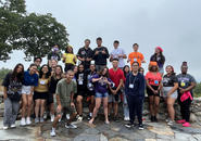 A group of students gathering outside at an orientation event