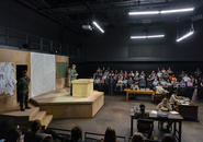 Scene from IPHIGENIA officer studying maps.