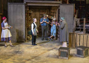 Shen Te feeds neighbors.