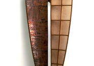 Copper and fiberglass sculpture shaped like canoe