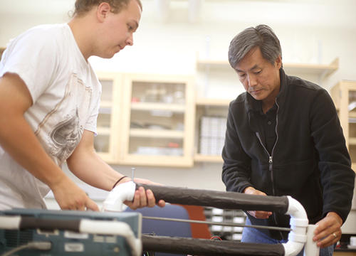 Samuel Habein '17 and Professor and Department Chair Tomohiko Narita build a cosmic ray telescope during Summer Research 2015.