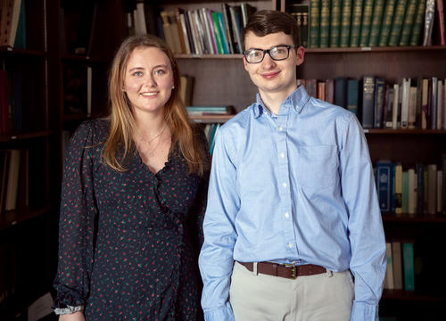 Two students, a woman and man posing for a picture