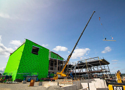 A beam is lifted into place at the Prior Center for Performing Arts