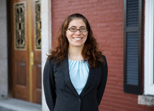 Rebecca Winarski stands in front of a door on Fenwick porch