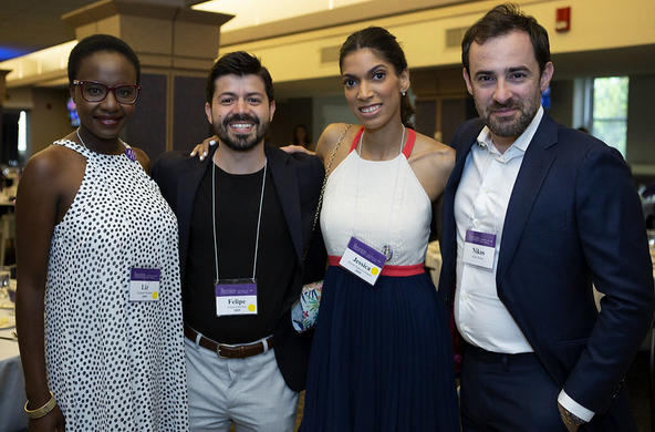 group of four alumni posing
