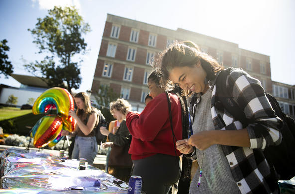 Students outside at an activity table.