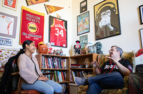 students sitting in a faculty office