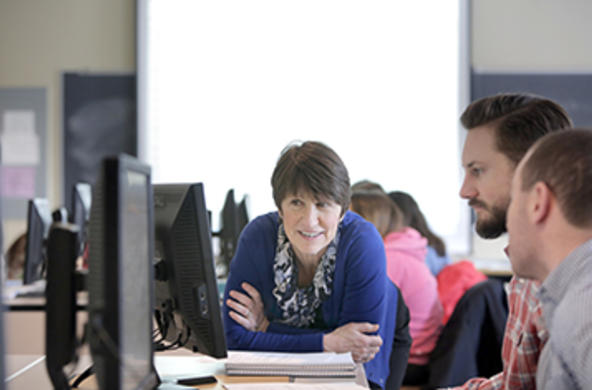 Students and a professor at a computer