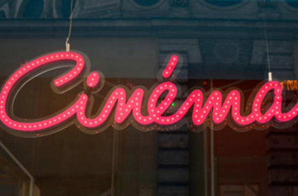 sign on window that reads cinema 