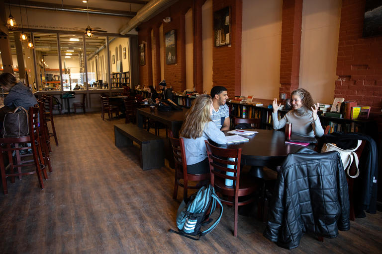 student and a professor meeting inside a coffee shop