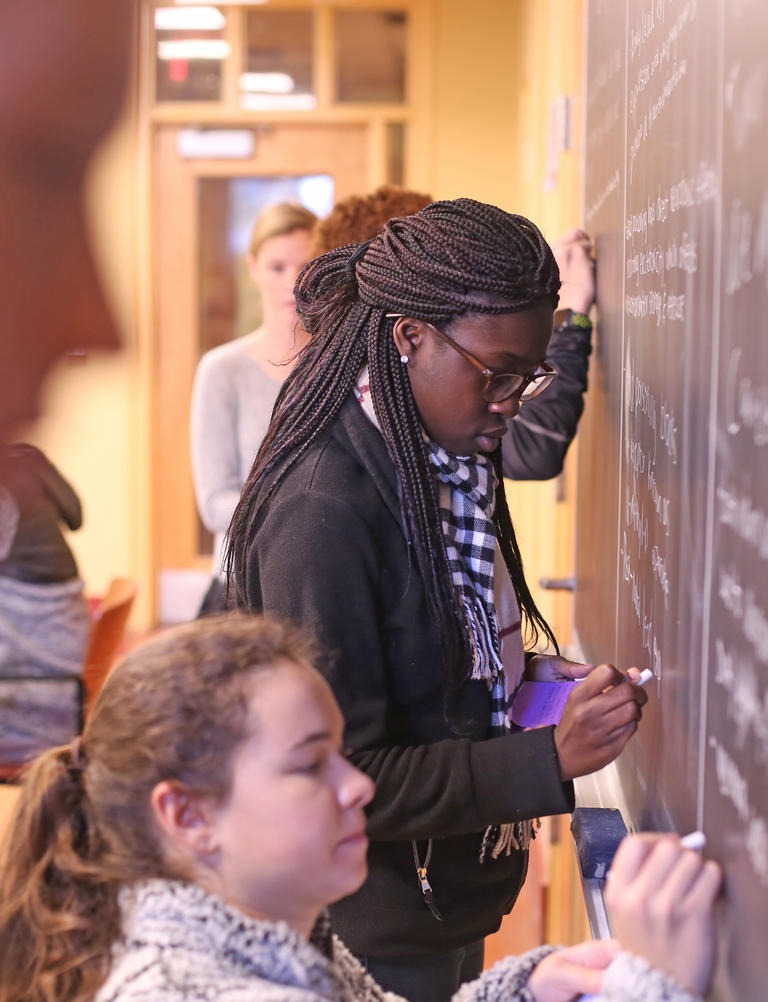student at a chalkboard 