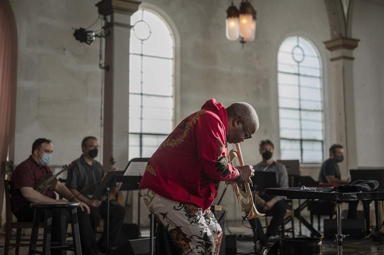 Terence Blanchard playing the trumpet, with the Turtle Island Quartet visible in the background