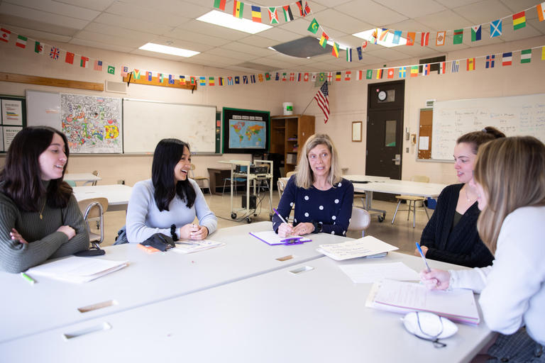 Assistant TEP Director meets with students during Field Placement at Burncoat High in Worcester.