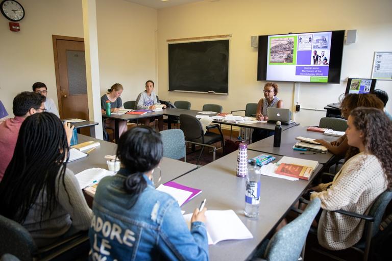 Students in a classroom sat around a u-shaped table.