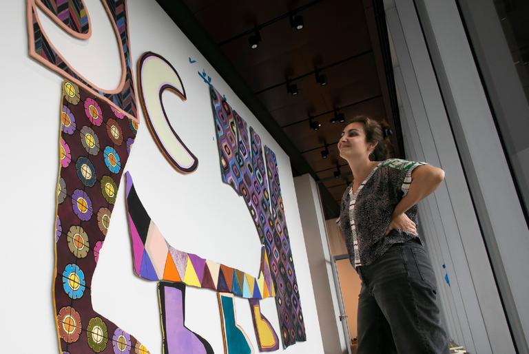 a large scale art installation featuring colorful panels on a white wall