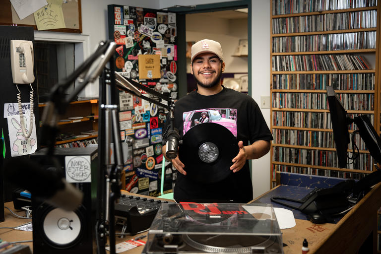 Holy Cross senior Bryan Rivas shown holding a record in a music studio
