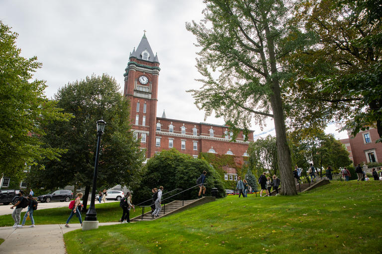 A shot of students walking on campus during a late spring/early summer day. 