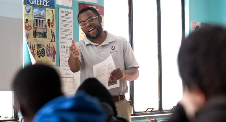 Teacher in front of the classroom engaging with the students.