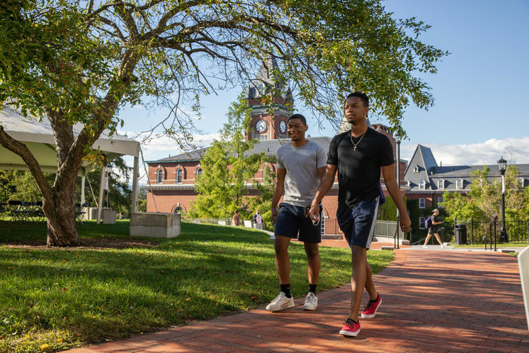 Two students walking on campus