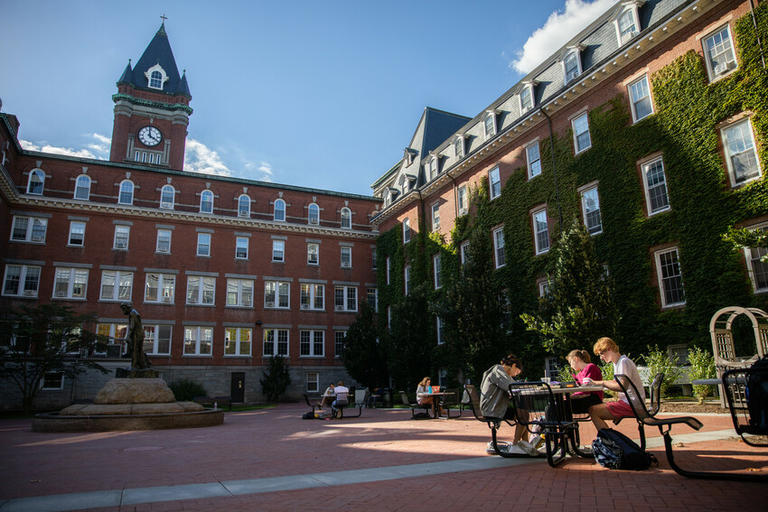 People sitting in memorial plaza on campus
