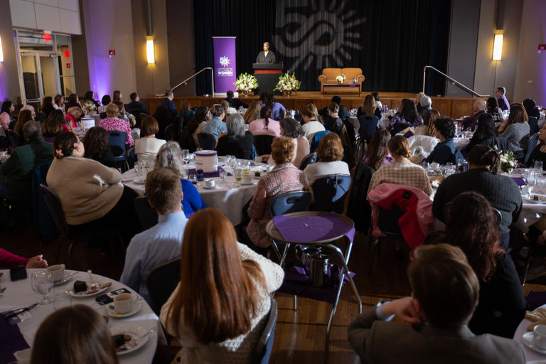 Audience listening to a speaker on stage