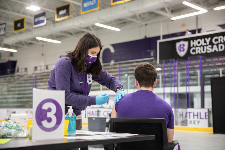 A worker providing health services to a student at Hoy Cross