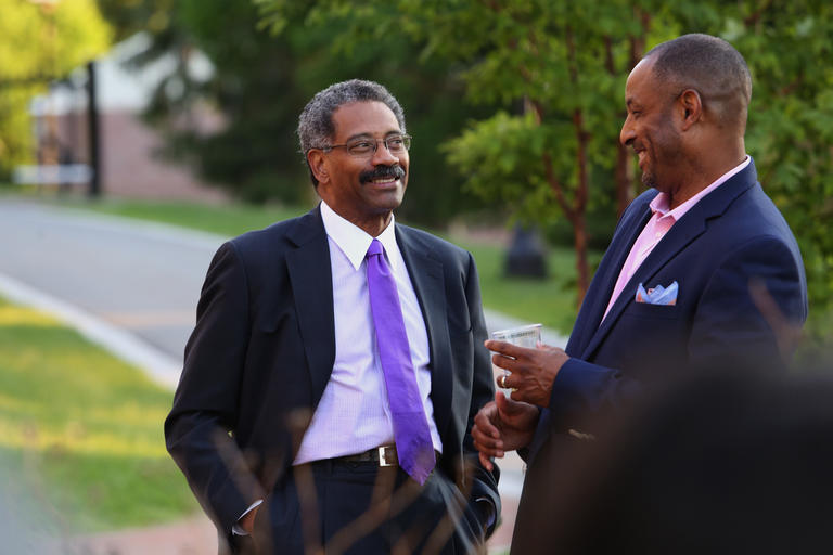 Two men in business suits engaged in conversation