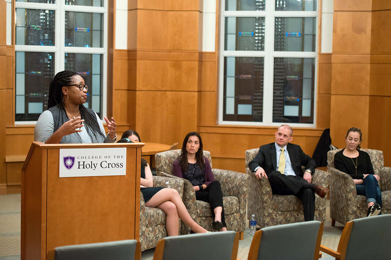 Melissa Nelson '10, a nurse midwife at OB-GYN Associates in Providence, R.I., speaks to students during an alumni panel. Other participants on the panel included, from left, Lauren Maloney '12, cooperative education advisor at Northeastern University’s D’Amore-McKim School of Business; Sandra van den Heuvel '14, clinical supervisor at Spectrum Health Systems; Tim Jarry '00, chief investment officer at Holy Cross; and Katherine Sutton '12, associate PR manager at Reebok US. 