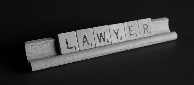 Scrabble tiles spelling Lawyer