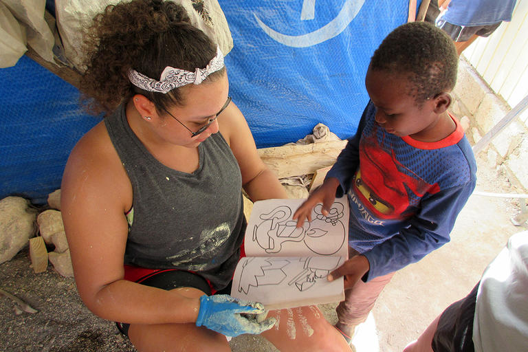 A Holy Cross student interacts with a student on an immersion program.