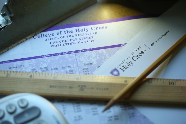 Desk with a copy of transcript, pencil, ruler and calculator