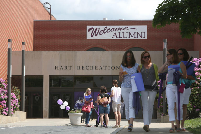 People walking down sidewalk outdoors