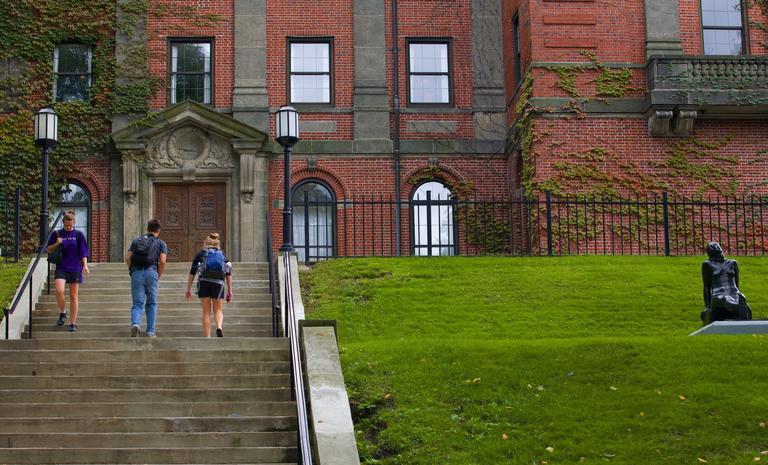 Students are walking up the stairs to the Library