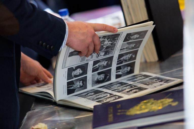 Person flipping through a yearbook