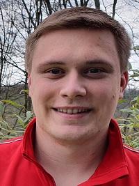 blond hair student smiling with red shirt