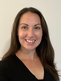 close up of faculty member with smiling at the camera