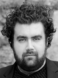 image of a man looking at the camera he has short hair with facial hair